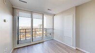 Located on the 22nd floor at 140 Main Street West in downtown Hamilton, this thoughtfully designed one-bedroom, one-bathroom unit offers a modern and efficient layout with quality finishes throughout. Light wood-tone laminate flooring flows seamlessly through the main living areas and bedroom, complementing the neutral grey and beige palette that defines the space.

The open living area is bathed in natural light, courtesy of expansive floor-to-ceiling windows and a sliding glass door that leads to a private balcony. From this elevated vantage point, sweeping views of the Hamilton cityscape and surrounding landscape stretch across the horizon. The kitchen features dark wood cabinetry with ample storage and stainless steel appliances, positioned conveniently adjacent to the living area.

The bedroom is a well-proportioned retreat finished with the same light hardwood flooring, offering a dedicated closet with built-in rod and shelving. A second large window provides additional natural light and city views, enhancing the airy feel of the room.

The bathroom is finished in a clean, all-white palette featuring a tiled tub-shower combination, a stone-topped vanity, and chrome fixtures. A dedicated laundry area and in-unit closet round out this well-appointed home, making it a practical and stylish urban residence in the heart of Hamilton.