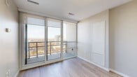 Located on the 22nd floor at 140 Main Street West in downtown Hamilton, this thoughtfully designed one-bedroom, one-bathroom unit offers a modern and efficient layout with quality finishes throughout. Light wood-tone laminate flooring flows seamlessly through the main living areas and bedroom, complementing the neutral grey and beige palette that defines the space.

The open living area is bathed in natural light, courtesy of expansive floor-to-ceiling windows and a sliding glass door that leads to a private balcony. From this elevated vantage point, sweeping views of the Hamilton cityscape and surrounding landscape stretch across the horizon. The kitchen features dark wood cabinetry with ample storage and stainless steel appliances, positioned conveniently adjacent to the living area.

The bedroom is a well-proportioned retreat finished with the same light hardwood flooring, offering a dedicated closet with built-in rod and shelving. A second large window provides additional natural light and city views, enhancing the airy feel of the room.

The bathroom is finished in a clean, all-white palette featuring a tiled tub-shower combination, a stone-topped vanity, and chrome fixtures. A dedicated laundry area and in-unit closet round out this well-appointed home, making it a practical and stylish urban residence in the heart of Hamilton.