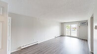 Located at 83 Mansfield Rd in New London, Connecticut, this two-bedroom, one-bathroom residence offers a well-organized single-level layout designed for comfortable everyday living. The bright and open living area features light hardwood-style flooring, a textured ceiling, baseboard heating, and a sliding glass door that opens to a private balcony, filling the space with natural light and providing outdoor views. A wall-mounted AC unit ensures year-round comfort. The kitchen has been thoughtfully updated with white shaker-style cabinetry, granite-look countertops, a stainless steel sink, and a full suite of stainless steel appliances including a range, microwave, and dishwasher. Hardwood-style flooring continues throughout the kitchen, which connects seamlessly to the rest of the unit via a central hallway. The generously sized primary bedroom features plush carpeting, a closet, and a bright window with outdoor views. The second bedroom also offers carpeted flooring, hardwood-style planks in select areas, a built-in closet, and access to additional shelved storage. The full bathroom includes a tub-shower combination and wood-style flooring. Throughout the home, a clean, neutral palette and functional layout create a bright, move-in-ready living environment.