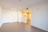 Located at 3115 Finnian Way in Dublin, CA, this two-bedroom, one-bathroom single-floor residence offers a well-organized and efficient layout. The open-plan living and dining area is bright and airy, featuring light wood-style flooring and a sliding glass door that leads to a private patio, allowing natural light to fill the space and providing easy outdoor access. The kitchen is positioned adjacent to the living area with a pass-through breakfast bar, light wood cabinetry extending to the ceiling, ample counter space, and white appliances including a gas range, over-the-range microwave, and refrigerator. Both bedrooms are carpeted and well-lit with large windows fitted with vertical blinds that offer outdoor views. The primary bedroom includes a walk-in closet with wire shelving, while the secondary bedroom features a double sliding-door closet. A third closet provides additional storage elsewhere in the unit. The full bathroom is equipped with a combined tub and shower, a generous vanity with light wood cabinetry, and wood-style flooring. A hallway connects the main living spaces, and an entry area with panel access completes the thoughtfully arranged floor plan.