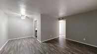 This efficiently designed one-bedroom, one-bathroom residence in Denton, TX offers a thoughtfully organized single-story layout that maximizes every square foot. Throughout the home, durable wood-look plank flooring in a warm gray tone creates a cohesive, modern aesthetic, complemented by neutral gray walls and crisp white trim.

The open living room provides a generous, versatile space filled with natural light, offering room for comfortable furnishings and everyday living. It connects seamlessly to the rest of the home, creating an easy flow between spaces.

The kitchen is well-equipped with white cabinetry, a subway tile backsplash, a stainless steel sink, and black appliances including a refrigerator, electric range, and dishwasher — all arranged in a practical galley-style configuration that maximizes efficiency.

The bedroom is a comfortably sized private retreat featuring a bright window with blinds that invite natural light, neutral walls, and the same wood-look flooring found throughout. A dedicated closet provides convenient storage.

The bathroom is clean and functional, featuring a full tub-shower combination with white tile surround, chrome fixtures, and white cabinetry above for additional storage. This residence offers a practical and stylish living space in a convenient Denton location.