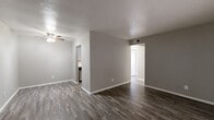 This efficiently designed one-bedroom, one-bathroom residence in Denton, TX offers a thoughtfully organized single-story layout that maximizes every square foot. Throughout the home, durable wood-look plank flooring in a warm gray tone creates a cohesive, modern aesthetic, complemented by neutral gray walls and crisp white trim.

The open living room provides a generous, versatile space filled with natural light, offering room for comfortable furnishings and everyday living. It connects seamlessly to the rest of the home, creating an easy flow between spaces.

The kitchen is well-equipped with white cabinetry, a subway tile backsplash, a stainless steel sink, and black appliances including a refrigerator, electric range, and dishwasher — all arranged in a practical galley-style configuration that maximizes efficiency.

The bedroom is a comfortably sized private retreat featuring a bright window with blinds that invite natural light, neutral walls, and the same wood-look flooring found throughout. A dedicated closet provides convenient storage.

The bathroom is clean and functional, featuring a full tub-shower combination with white tile surround, chrome fixtures, and white cabinetry above for additional storage. This residence offers a practical and stylish living space in a convenient Denton location.