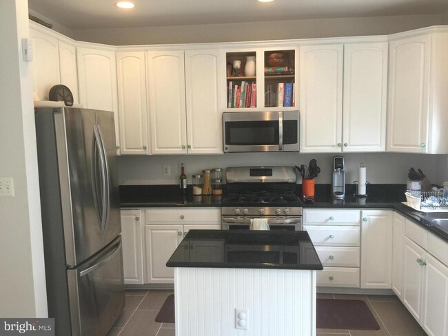 Kitchen with island and breakfast nook - 8706 Ramsey Ave