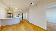 Located at 101 Laurel Hill Rd in Brookfield, CT, this thoughtfully designed one-bedroom, one-bathroom residence offers a well-appointed single-floor layout with modern finishes throughout. Wide-plank hardwood flooring flows seamlessly across the entire living space, creating a warm and cohesive aesthetic.

The open-concept living, dining, and kitchen area serves as the heart of the home. The kitchen is outfitted with light wood flat-front cabinetry, stainless steel appliances including a refrigerator, range, and microwave, a white subway tile backsplash, and a central island with a white quartz countertop, undermount sink, and matte black faucet. Globe pendant lights hang above the island, adding a contemporary touch.

The bedroom is a comfortable, well-lit retreat featuring a double-door closet with classic paneled doors and two large black-framed windows that invite natural light and offer views of the surrounding wooded landscape. An additional closet provides extra storage elsewhere in the unit.

The bathroom is finished in neutral tile with a glass-enclosed walk-in shower, wood-toned vanity, and matte black hardware, delivering a clean, spa-like feel. A dedicated laundry room and hallway round out the functional layout of this move-in-ready residence.