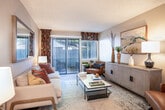 Located at 34050 Westchester Terr in Fremont, CA, this well-appointed one-bedroom, one-bathroom residence offers a thoughtfully designed single-floor layout. The combined living and dining area forms the heart of the home, where the living room features large sliding glass doors that flood the space with natural light and open directly onto a private patio. The dining area is defined by a ceiling fan, a bright window with outdoor views, and a built-in shelving unit that adds both storage and character. The galley-style kitchen is outfitted with white cabinetry, dark countertops, wood-look flooring, and a full suite of appliances including a refrigerator, range, and dishwasher. The bedroom is a comfortable retreat with plush carpet, a ceiling fan, a large window, and a mirrored sliding-door closet. Two additional closets provide generous storage throughout. The bathroom includes a single-sink vanity with dark countertop, white cabinetry, wood-look flooring, and a shower-tub combination. A dedicated laundry area and a welcoming hallway entry complete the layout. The space maintains a neutral, warm palette throughout, creating a cohesive and inviting atmosphere.