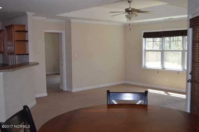 Open floor plan into the living room from the dining space. - 112 Oyster Landing Drive