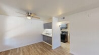 Located at 824 W Gurley St in Prescott, Arizona, this one-bedroom, one-bathroom unit offers a well-organized single-floor layout designed to maximize functionality. The living room greets you upon entry through a classic paneled door, featuring light wood-style laminate flooring, neutral cream-toned walls, and a ceiling fan with integrated lighting. A window allows natural light to filter in, while a wall-mounted AC unit provides climate control. The space flows seamlessly into the kitchen, which is outfitted with gray shaker-style cabinetry, a range hood, a black electric coil range, a matching black refrigerator, and a single-basin sink with light countertops — offering all essential cooking amenities in an efficient galley-style arrangement. The bedroom is a comfortable, well-proportioned room with the same warm laminate flooring, soft neutral walls, and a window fitted with blinds that overlook the exterior. The bathroom continues the cohesive design with matching flooring, white fixtures including a toilet and a bathtub with an overhead shelf for storage. Throughout the unit, clean lines, consistent finishes, and thoughtful use of space create a practical and move-in-ready living environment in the heart of Prescott.
