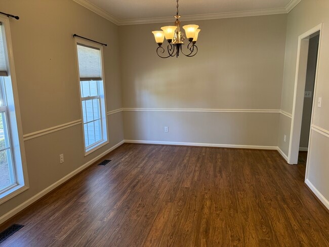 The Dining Room is also located on the front of the home with chair rail and crown moldings - 6419 Woodmont Rd