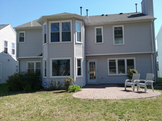 Back view of home with brick patio - 2069 Cheshire Forest Ct