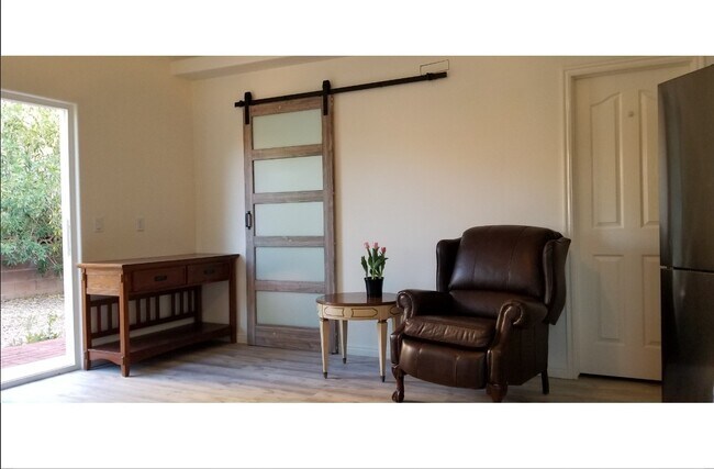 2. Studio entrance & E & N-facing living room (garden views + patio door with privacy blinds) - 137 E 755 S