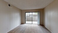Located at 8550 Florin Rd in Sacramento, CA, this single-floor residence offers a practical and efficiently designed layout with two bedrooms and two bathrooms. The living area features neutral-toned carpet and a textured ceiling, with a large sliding glass door that opens to a private patio, filling the space with natural light and providing outdoor views of surrounding greenery. The kitchen is equipped with white cabinetry, light stone-patterned countertops, a built-in microwave, electric range, and refrigerator. Wood-look flooring runs throughout the kitchen, adding warmth and durability. A pass-through counter connects the kitchen to the main living area, enhancing the open feel. The primary bedroom is generously sized with plush carpet, a window overlooking outdoor greenery, and a sliding-door closet with built-in shelving for ample storage. The second bedroom is similarly carpeted and well-lit by a window. Both bathrooms feature wood-look flooring, vanities with stone-patterned countertops, and clean white fixtures. The overall ambiance is clean, neutral, and move-in ready, making this a functional and comfortable home.