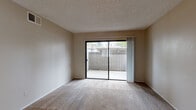 Located at 8550 Florin Rd in Sacramento, CA, this single-floor residence offers a practical and efficiently designed layout with two bedrooms and two bathrooms. The living area features neutral-toned carpet and a textured ceiling, with a large sliding glass door that opens to a private patio, filling the space with natural light and providing outdoor views of surrounding greenery. The kitchen is equipped with white cabinetry, light stone-patterned countertops, a built-in microwave, electric range, and refrigerator. Wood-look flooring runs throughout the kitchen, adding warmth and durability. A pass-through counter connects the kitchen to the main living area, enhancing the open feel. The primary bedroom is generously sized with plush carpet, a window overlooking outdoor greenery, and a sliding-door closet with built-in shelving for ample storage. The second bedroom is similarly carpeted and well-lit by a window. Both bathrooms feature wood-look flooring, vanities with stone-patterned countertops, and clean white fixtures. The overall ambiance is clean, neutral, and move-in ready, making this a functional and comfortable home.