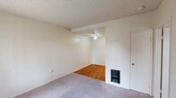 Located at 620 E St in Oxnard, California, this one-bedroom, one-bathroom unit offers a practical and well-organized single-floor layout. The living room features plush carpeting, a textured ceiling, and a wall-mounted heating vent, flowing seamlessly into the dining and kitchen area, which is distinguished by warm hardwood flooring and a ceiling fan overhead. Natural light enters through windows fitted with vertical blinds, brightening the neutral, cream-toned walls throughout the unit. The bedroom is a comfortable, carpet-floored room with its own window and direct access to a closet, providing functional storage. An additional closet elsewhere in the unit adds further organizational convenience. The bathroom includes a full-sized tub and shower combination with chrome fixtures and clean white surround walls. A textured popcorn ceiling is consistent throughout the space, lending a uniform character to each room. The layout is compact yet efficient, making smart use of every area. The unit's understated, neutral palette and practical features make it a straightforward and functional living space in a residential Oxnard neighborhood.