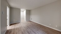 Located in Beaverton, Oregon, this well-appointed one-bedroom, one-bathroom unit offers a thoughtfully designed single-floor layout. The open-concept living, dining, and kitchen area serves as the heart of the home, finished with durable wood-look flooring and neutral gray tones that create a clean, modern aesthetic. A sliding glass door floods the living area with natural light and provides direct views of the surrounding green landscape outside.

The kitchen is a standout feature, outfitted with crisp white shaker-style cabinetry, white quartz countertops, stainless steel appliances including a refrigerator and electric range, a stainless steel sink, and light wood-look flooring — combining both style and functionality.

The bedroom offers a comfortable, carpeted retreat with a window framing views of mature trees, a built-in closet, and a wall heating unit. An additional closet in the unit provides ample storage. The bathroom includes a full tub/shower combination, white vanity cabinetry, and light wood-look flooring, maintaining the cohesive modern aesthetic found throughout the space.

With two closets, an entrance area, and a seamlessly connected main living zone, this unit delivers efficient, practical living in a well-maintained Beaverton location.