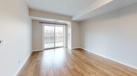 Located at 57 Riverview Dr in Chatham-Kent, Ontario, this well-appointed two-bedroom, two-bathroom unit offers a thoughtfully designed single-floor layout with modern finishes throughout. Warm light hardwood flooring flows consistently across all rooms, creating a cohesive and inviting atmosphere.

The open-concept kitchen and living area serves as the heart of the unit. The kitchen is equipped with crisp white cabinetry, quartz countertops, stainless steel appliances including a range, over-the-range microwave, and refrigerator, as well as a peninsula with an integrated sink — ideal for both cooking and casual dining. The living area extends naturally from the kitchen and features a sliding glass door that opens to an outdoor balcony, allowing natural light to fill the space and offering pleasant views of the surrounding greenery.

The primary bedroom is a comfortable, well-sized room with a large window framing outdoor views, while the second bedroom includes a sliding closet for practical storage. Both bathrooms are finished in clean, contemporary style — one featuring a glass-enclosed walk-in shower with subway tile surround and a vanity with ample cabinetry, and the other offering a full soaker tub with tiled surround. The overall design is clean, bright, and modern throughout.