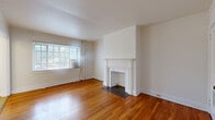 Located in the historic village of Mariemont, Ohio, this one-bedroom, one-bathroom residence offers a thoughtfully arranged single-floor layout with timeless architectural character. The living room serves as the heart of the home, showcasing rich hardwood flooring that extends throughout, a classic white-mantled decorative fireplace as a focal point, and a large multi-pane window that fills the room with natural light. A central hallway connects the living spaces efficiently, with clean white panel doors and crisp trim work lending a cohesive, traditional aesthetic. The bedroom is a comfortable retreat, featuring the same warm hardwood floors and a generously sized window that brings in additional natural light. The galley-style kitchen is efficiently designed with warm wood cabinetry, a white countertop with an integrated sink, tile flooring, and includes a gas range and refrigerator. The bathroom offers a full tub-shower combination with white tile surround, a vanity with under-sink cabinetry, a medicine cabinet mirror, and a window for ventilation. Throughout the space, white walls, consistent trim detailing, and hardwood flooring create a unified, classic ambiance well-suited to the charm of the Mariemont neighborhood.