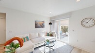 Located at 43738 Buena Vista Way in Lancaster, CA, this single-story, one-bedroom, one-bathroom residence offers a well-designed and efficiently organized floor plan. The interior is finished with light hardwood-style flooring throughout, crisp white walls, and recessed lighting, creating a clean and contemporary aesthetic.

The living room serves as the heart of the home, bathed in natural light from large sliding glass doors that open directly to a private outdoor patio — ideal for indoor-outdoor living. The space feels open and airy, with a welcoming ambiance suited for both relaxing and entertaining.

The kitchen is well-appointed with dark espresso-toned cabinetry, a full suite of stainless steel appliances including a refrigerator, dishwasher, microwave, and range, as well as white countertops and a bright window that brings in additional natural light.

The bedroom is a comfortable retreat featuring a window with blinds for natural light and privacy, a ceiling-mounted HVAC unit, and easy access to an adjacent closet. The room is finished with the same neutral palette found throughout the home.

The bathroom features a dark wood vanity with a white countertop, a large mirror, and a shower-tub combination with a glass enclosure, all set on light hardwood-style flooring. A hallway connects the rooms seamlessly, completing this thoughtfully laid-out residence.