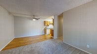 Located at 21701 Foothill Blvd in Hayward, California, this single-floor residence offers a practical and comfortable layout suited for everyday living. The open living and dining area features a combination of hardwood-style flooring and plush carpeting, with a ceiling fan overhead and a textured ceiling throughout. A wall-mounted AC unit and a front entry door with a window allow for natural light and ventilation. The space flows seamlessly into the galley-style kitchen, which is equipped with warm wood cabinetry, blue-toned countertops, a white dishwasher, electric range, and refrigerator, all set atop hardwood-style flooring. The bedrooms are carpeted and neutral in tone, each offering closet space and windows that bring in natural light, including views of surrounding greenery. One bedroom features a baseboard heater. The full bathroom includes a wood-vanity with a blue countertop, a single sink, and a shower-tub combo with clean white surrounds. Throughout the residence, neutral gray walls and consistent finishes create a cohesive, move-in-ready atmosphere well-suited for comfortable, practical living.