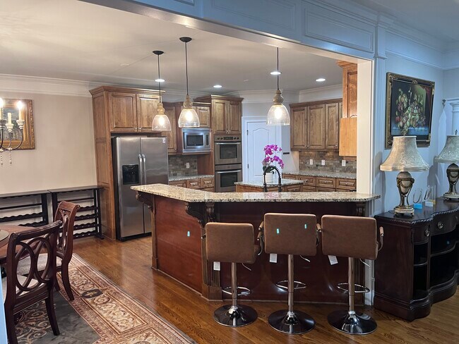 Kitchen - Kitchen featuring stainless steel appliances, tasteful backsplash, light stone counters, d - 7987 Magnolia Sq