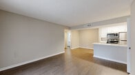 Located at 2480 Cypress Pond Rd in Palm Harbor, Florida, this 2-bedroom, 1-bathroom residence offers a well-designed single-floor layout that maximizes functionality and comfort. The interior features consistent wood-look flooring throughout, neutral gray walls, and textured ceilings that create a clean, cohesive aesthetic.

The open-concept living, dining, and kitchen area forms the heart of the home. The living room is generously proportioned, filled with natural light from a large sliding glass door fitted with vertical blinds that opens onto a private balcony with greenery views. The kitchen is designed for efficiency, featuring white cabinetry, light countertops, a skylight, a pantry, and a full suite of stainless steel appliances including a range, microwave, refrigerator, and dishwasher.

Both bedrooms offer wood-look flooring, neutral tones, and natural light from windows with blinds. The primary bedroom includes a built-in closet, while additional closet storage is available throughout the unit, totaling three closets.

The bathroom is bright and clean, appointed with a white vanity, quartz-style countertop, brushed nickel hardware, a mirror, and a full tub-shower combination with tiled surround. A dedicated entrance completes this practical and comfortable Palm Harbor residence.