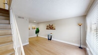 Located at 9312 Beck Avenue in Dallas, TX, this two-story, one-bedroom, one-bathroom home offers a thoughtfully laid out living space spread across two equally sized floors connected by a wood-tread staircase. The main floor features a welcoming living room with light hardwood flooring, neutral warm-gray walls, a textured ceiling, and a front-facing window that invites natural light and outdoor views. Adjacent to the living area is a well-appointed kitchen showcasing white shaker cabinetry, granite countertops with subtle veining, a white subway tile backsplash, and a matte black faucet with an under-mount stainless steel sink — a clean, modern aesthetic throughout. The upper floor hosts the generously sized primary bedroom, which continues the light hardwood flooring, features neutral toned walls, a textured ceiling, and a ceiling fan with an integrated light fixture. A dedicated closet and hallway provide practical storage and circulation on this level. The bathroom is finished with large-format marble-look tile surrounding a soaking tub and shower combination, complemented by chrome fixtures. Clean lines, consistent neutral tones, and updated finishes give the entire home a cohesive, move-in-ready character.