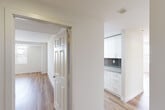 Located at 50 Park Row W in the heart of Providence, Rhode Island, this well-appointed 2-bedroom, 2-bathroom residence offers a clean, modern aesthetic throughout. Warm hardwood-style flooring flows continuously across the entire floor plan, complementing the bright white walls and creating a cohesive, inviting atmosphere.

The spacious living and dining area is a standout feature, bathed in natural light from large windows and floor-to-ceiling sliding glass doors that open to a private balcony with urban views of the Providence skyline. This open layout provides a generous and versatile entertaining space.

The galley-style kitchen is thoughtfully designed with crisp white cabinetry, sleek grey subway tile backsplash, light quartz-style countertops, and stainless steel appliances, including a refrigerator, range, and dishwasher. Ample upper and lower cabinet storage ensures excellent functionality.

The spacious primary bedroom features a dedicated window with natural light, while the second bedroom is equally well-proportioned. The unit includes four closets, providing abundant storage throughout. Two full bathrooms each include a tub-shower combination. An in-unit laundry area adds everyday convenience, rounding out this practical and attractive urban residence.