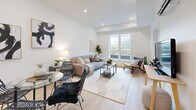This contemporary 48 square meter apartment showcases a thoughtful design that maximizes space and functionality. The open-concept layout seamlessly integrates the living area and kitchen, creating a sense of spaciousness. The kitchen boasts a modern aesthetic with white upper cabinets, light wood lower cabinets, and stainless steel appliances. A central island with a white countertop serves as both a workspace and casual dining area.

The living room is bathed in natural light from large windows, which offer scenic views. Furnished with a comfortable sofa, modern chairs, and a sleek coffee table, it provides an inviting space for relaxation. The bedroom continues the modern theme with a plush bed, stylish side tables, and ample natural light. Climate control is ensured by a wall-mounted air conditioning unit.

The bathroom features a clean, minimalist design with a white vanity, large mirror, and a combination bathtub-shower. Throughout the apartment, light wood flooring adds warmth to the predominantly white color scheme. Recessed lighting in the tray ceilings enhances the contemporary ambiance. This well-designed space efficiently accommodates all essential living areas within its compact 48 square meter footprint.