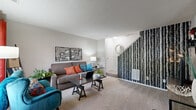 Located at 782 Millstream Dr in Reynoldsburg, Ohio, this two-story home offers a thoughtfully designed layout spread across two levels. The main floor welcomes you into a comfortable carpeted living room featuring a distinctive birch-tree accent wall along the staircase, a textured ceiling, and a bright window dressed with bold curtains that fill the space with natural light. The combined kitchen and dining area is equipped with warm wood cabinetry, dark countertops, and a full suite of stainless steel appliances, including a range, microwave, dishwasher, and refrigerator, all set atop durable hardwood-style flooring. A dedicated laundry area on the main level houses a full-size side-by-side washer and dryer with overhead shelving for added utility. Upstairs, the spacious primary bedroom features plush carpet, a large window, and ample room for a full furniture arrangement. The second bedroom also includes carpet, a window, and a sliding-door closet for convenient storage. The shared bathroom offers a wood-vanity with a wide single sink, white countertop, and a large wall mirror. With multiple closets and a utility room, this home provides practical storage solutions throughout both floors.