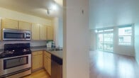 Located on the third floor at 1728 SW Jefferson Street in Portland's vibrant SW neighborhood, this apartment offers a clean, modern living environment designed for comfort and functionality. Light hardwood flooring runs consistently throughout the space, lending warmth and continuity to each room. The open-concept living area is bathed in natural light from large floor-to-ceiling windows and a sliding glass door that leads to a private balcony, offering views of the surrounding cityscape. The kitchen is thoughtfully designed with light maple cabinetry, gray countertops, stainless steel appliances including a refrigerator, range, microwave, and dishwasher, and a peninsula that provides a natural transition into the living space. The bedrooms feature large windows that bring in ample daylight, with one room showcasing mirrored sliding closet doors for added functionality. The bathroom includes a full bathtub and shower combination, a vanity with storage drawers, and a large mirror. Throughout the unit, neutral wall tones and clean lines create a bright, airy ambiance well-suited to a variety of interior styles. The overall layout is efficient and well-organized, making excellent use of the available space on a single floor.