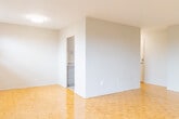 Located at 1061 Seneca Ave in Mississauga, Ontario, this three-bedroom, one-bathroom unit offers a functional and well-organized layout across a single floor. Classic parquet hardwood flooring runs throughout the living areas and bedrooms, lending warmth and a timeless character to the space.

The entrance leads into an open living area filled with natural light from large windows that frame views of the surrounding neighbourhood. Baseboard heating units are positioned throughout, ensuring consistent comfort. The galley-style kitchen is thoughtfully updated, featuring grey cabinetry with gold-toned hardware, granite-look countertops, a stainless steel sink, white appliances including a stove and refrigerator, and light tile flooring — all contributing to a clean, modern aesthetic.

The primary bedroom is generously proportioned and includes a built-in closet, a bright window with outdoor views, and the same warm parquet flooring found throughout. The two additional bedrooms are well-sized with neutral walls and ample natural light. The bathroom is clean and functional, equipped with a full tub-and-shower combination, white tile surround, and a granite-accented vanity. The overall ambiance of the unit is bright, neutral, and move-in ready.