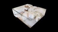 This 760-square-foot, 2-bedroom, 1-bathroom apartment at 201 8th Avenue Northwest in Austin, MN, offers a thoughtfully designed modern living space with industrial-chic architectural details. The open-concept kitchen and living area features light hardwood flooring, large floor-to-ceiling windows, and exposed metal ductwork that lends an urban character to the space. The kitchen is equipped with warm walnut-toned cabinetry, quartz countertops, stainless steel appliances including a refrigerator, range, and microwave, a built-in dishwasher, and a peninsula island with pendant lighting. The living area extends to a private balcony through sliding glass doors, offering views of the surrounding cityscape and nearby waterway. The primary bedroom spans 130 square feet and features plush carpet flooring, large windows with outdoor views, and exposed ductwork consistent with the unit's industrial aesthetic. The second bedroom is carpeted and bright, with clean white walls. A spacious walk-in closet provides ample wire-rack storage. The full bathroom includes a tub-shower combination, a wood-cabinet vanity with a white countertop, and light hardwood-style flooring with black matte fixtures throughout.