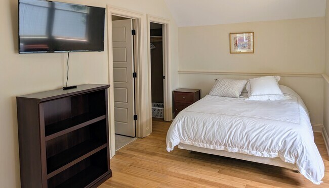 Bed, doors to bathroom and closet - 217 W Winmore Ave