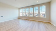 Located at 775 Morton St E in Boston, MA, this 2-bedroom, 1-bathroom unit offers a well-designed single-floor layout with modern finishes throughout. Light hardwood flooring flows consistently across every room, complementing the neutral, warm-toned walls and crisp white trim.

The open kitchen and living area forms the heart of the unit. The kitchen is outfitted with white shaker-style cabinetry, a full suite of stainless steel appliances including a range, over-the-range microwave, dishwasher, and side-by-side refrigerator, and a gold-accented faucet at the sink. The adjacent living area benefits from a generous bank of large double-hung windows that flood the space with natural light and frame views of the surrounding Boston neighborhood rooftops.

Both bedrooms are well-proportioned, featuring large windows with similar neighborhood views, recessed lighting, and the same light hardwood flooring. The primary bedroom offers a comfortable, versatile footprint.

The bathroom is finished with marble-look tile flooring, a white vanity with gold hardware, a framed mirror, and a full tub-shower combination. The overall design is clean, contemporary, and cohesive throughout the unit.