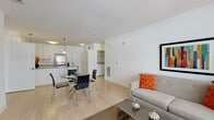 This well-designed 2-bedroom, 2-bathroom residence at 21 Willet Ave, Unit 213 in Port Chester, NY offers a thoughtfully planned single-floor layout that balances comfort and modern style. The open-concept living and dining area flows seamlessly into a contemporary kitchen, where sleek white upper cabinetry, light grey lower cabinets, a subway tile backsplash, stainless steel appliances, and a peninsula with an undermount sink create an inviting space for cooking and entertaining. Light hardwood-style flooring extends throughout the main living areas, enhancing the bright, airy atmosphere. The living room is generously proportioned, with a large window that allows natural light to fill the space. Both bedrooms are carpeted and well-sized, each offering ample natural light. The primary bedroom includes access to a walk-in closet with wire shelving. Two full bathrooms feature clean, modern finishes, including subway tile surrounds, white vanities with quartz-style countertops, and tile flooring. A dedicated in-unit laundry area adds everyday convenience. The overall aesthetic is clean and contemporary throughout, with a neutral color palette and modern fixtures that provide a polished, move-in-ready living environment.