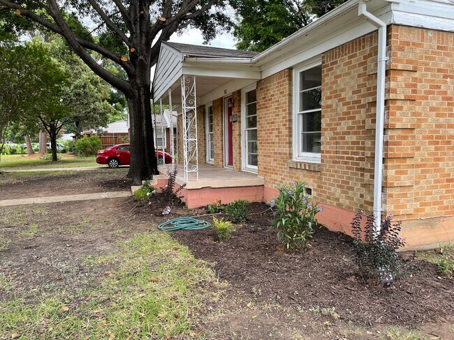 Side of house with new plants being added. - 102 E Ireland Dr