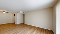 This well-appointed apartment at 8300 Allerton Ct in Lyndon, Kentucky offers a practical and comfortable single-floor layout with three bedrooms, three bathrooms, a living room, dining room, kitchen, hallway, and an impressive seven closets throughout. The living room is bright and welcoming, featuring light wood-style flooring, neutral walls, a textured ceiling, and a sliding glass door with vertical blinds that fills the space with natural light. The kitchen is equipped with warm, rich wood cabinetry, granite-style countertops, white appliances including a range, dishwasher, and refrigerator, and connects seamlessly to the dining area, which is accented by a ceiling fan. The spacious primary bedroom offers generous proportions with soft carpeting, while the additional bedrooms also feature carpet flooring and windows with blinds that invite natural light. Each of the three bathrooms is cleanly finished, with one featuring a wood-cabinet vanity with a large mirror and another with a full tub-shower combo on tile flooring. The unit maintains a consistent, neutral color palette throughout, with textured ceilings and clean white trim providing a cohesive aesthetic across every room.