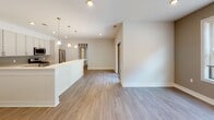 Located at 919 Sunnyview Oval in Fords, NJ, this well-appointed 2-bedroom, 2-bathroom residence offers a thoughtfully designed single-level floor plan with modern finishes throughout. Warm hardwood-style flooring flows continuously across the living spaces, complemented by crisp white walls and clean-lined trim work including elegant crown molding in select rooms.

The open-concept kitchen is a standout feature, showcasing white shaker-style cabinetry reaching to the ceiling, a gray subway tile backsplash, light quartz countertops, and a full suite of stainless steel appliances including a gas range, over-the-range microwave, and refrigerator. A peninsula with beadboard detailing and pendant lighting above connects the kitchen seamlessly to the expansive living and dining area, which is bathed in natural light.

Both bedrooms are generously proportioned, with ceiling fans, large windows offering outdoor greenery views, and crown molding details. The primary bathroom features light tile flooring, a vanity with ample counter space, a natural light window, and a tiled walk-in shower. A second full bathroom provides additional convenience with a clean, neutral palette and tile flooring. The overall ambiance is bright, fresh, and move-in ready.