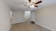 Located at 3106 E 51st St in Tulsa, Oklahoma, this single-story home offers a well-organized layout with a neutral color palette and a blend of practical finishes throughout. The main living area features plush carpeting, warm beige walls, and a ceiling fan with integrated lighting, creating a comfortable and functional space. An adjacent area, accented by a chandelier, provides a defined dining or secondary gathering space, with a panel door serving as the entry point between zones.

The bedrooms continue the carpeted flooring and neutral tones, each equipped with ceiling fans. One bedroom benefits from a sliding glass door fitted with vertical blinds, allowing natural light to filter in. The kitchen is outfitted with warm wood cabinetry, granite-style countertops, tile flooring, and stainless steel appliances including a refrigerator, gas range, microwave, and dishwasher, along with recessed lighting overhead.

The bathroom features wood-look vinyl plank flooring, a warm-toned vanity with granite countertops, and a separate wet area with a full tub and white tile surround. White trim and baseboards are consistent throughout, contributing to a clean, cohesive appearance across the entire home.