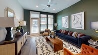 Located at 4015 Aspen Grove Dr in Franklin, TN, this thoughtfully designed single-floor residence blends bold color choices with modern finishes throughout. The open-concept kitchen is a standout, featuring floor-to-ceiling white shaker cabinetry, a dark subway tile backsplash, stainless steel appliances, quartz countertops, and a large island with a built-in sink and pendant lighting — all flowing seamlessly into the living area. The living room is anchored by a rich deep green accent wall, wood-look flooring, recessed lighting, a ceiling fan, and generous natural light from large windows and a glass-panel exterior door. The bedrooms offer vibrant coral and pink accent walls, ceiling fans, and ample natural light, creating warm and energetic retreats. Two well-designed bathrooms serve the space: one features wood-look tile flooring and a tub-shower combination, while the other offers a dual-sink vanity with white countertops and a glass-enclosed shower. The cohesive use of wood-look flooring, recessed lighting, and bold accent colors throughout gives this residence a lively yet polished character, making it a distinctive and welcoming home in the heart of Franklin, Tennessee.