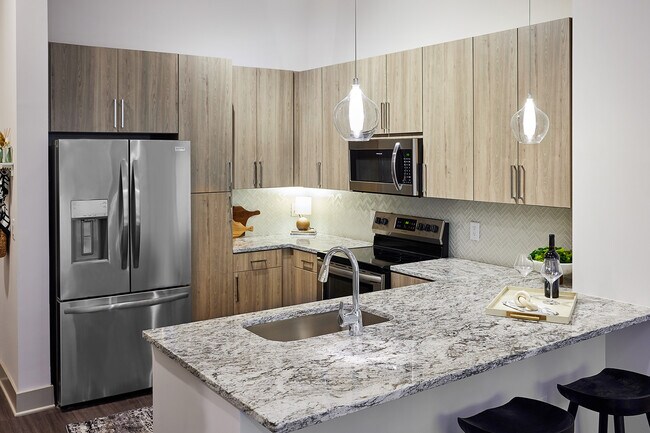 Cocina moderna con acabados elegantes. - Passport Apartments