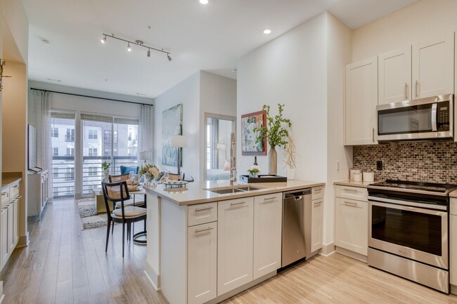 Stunning kitchens feature quartz countertops and tiled backsplash. - Windsor Mystic River