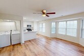 Located at 101 Whitsell Way in Pontoon Beach, IL, this single-floor, 2-bedroom, 1-bathroom home offers a clean, modern interior with a thoughtfully designed open floor plan. The combined kitchen and living area forms the heart of the home, highlighted by light hardwood-style flooring, recessed lighting, and a ceiling fan that anchors the space. Large multi-pane windows flood the living area with natural light, creating a bright and airy atmosphere.

The kitchen is well-appointed with white shaker-style cabinetry extending to the ceiling, granite countertops, a central island with additional counter space, and a full suite of stainless steel appliances including a refrigerator, range, microwave, and dishwasher. A dedicated pantry provides additional storage convenience.

Both bedrooms feature the same warm hardwood-style flooring, ceiling fans with light fixtures, and windows that invite natural light. The primary bedroom offers a comfortable footprint, while the second bedroom is similarly functional. The home also includes three closets, an in-unit laundry area, and a utility room, rounding out a practical and efficient layout suited for everyday living.