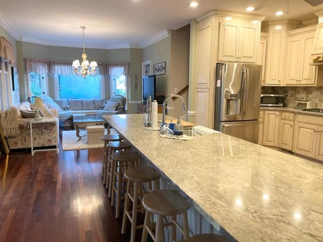 Oversized kitchen with granite countertops and mostly stainless appliances. Seating for 10 at the is - 4916 Samuel Pinckney Dr