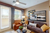 Located at 8165 W Whitney Dr in Peoria, Arizona, this single-story, 2-bedroom, 2-bathroom home offers a thoughtfully designed layout with contemporary finishes throughout. Light wood-style flooring flows seamlessly across the entire floor plan, creating a cohesive and airy feel.

The living room is a welcoming space anchored by warm neutral tones, a ceiling fan, and large windows with access to an outdoor area, allowing natural light to fill the room. The kitchen is a standout feature, showcasing light wood cabinetry, white quartz countertops, a soft blue tile backsplash, stainless steel appliances including a refrigerator, range, and microwave, as well as a kitchen island and deep single-basin sink.

The spacious primary bedroom includes a walk-in closet and direct access to its en-suite bathroom, which features a long wood-toned vanity, white quartz countertop, and a glass-enclosed shower. The second bedroom also includes its own closet and is served by a full bathroom with a tub-shower combination, wood-toned cabinetry, and rich textured wall finishes.

Connecting hallways are bright and tastefully appointed. A dedicated laundry area houses a stacked Whirlpool washer and dryer unit. The home offers two closets and a functional, well-organized floor plan ideal for comfortable everyday living.