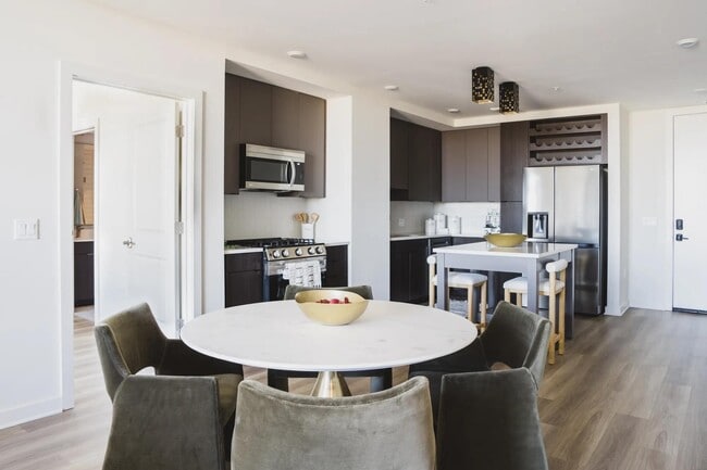 Cook in style with gourmet kitchens, single basin sinks and sleek tile backsplash. - Modera Parkside