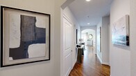 Located at 2323 McCue Rd in Houston's upscale Galleria district, this well-appointed 2-bedroom, 2-bathroom residence offers a thoughtfully designed single-floor layout. Rich hardwood flooring runs throughout the main living areas, beginning at the welcoming entry hallway adorned with curated artwork and an elegant arched passage leading to the living room.

The bright, open living room is a standout, featuring crown molding, a ceiling fan, and floor-to-ceiling sliding glass doors that open to a private balcony with sweeping Houston city skyline views. The kitchen is well-equipped with warm wood cabinetry, dark granite countertops, stainless steel appliances, and a classic tile backsplash.

The primary bedroom offers a serene retreat with a neutral accent wall and generous proportions. Both bathrooms are finished with travertine-style tile, and include a soaking tub and shower combination. A dedicated office provides a quiet workspace with carpeted flooring and built-in shelving. The second bedroom is bright and versatile, with natural light and soft carpet. Two closets and two hallways provide ample storage and circulation throughout the residence, making this an organized and functional home in a prime Houston location.