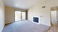 Located at 7971 Rush River Dr in Sacramento, CA, this well-appointed two-bedroom, two-bathroom residence offers a thoughtfully designed single-floor layout. The open kitchen is fitted with stainless steel appliances, including a refrigerator, range, microwave, and dishwasher, complemented by crisp white shaker cabinetry, granite-style countertops, and light wood-look flooring. A peninsula counter connects the kitchen to the living area, which is finished with a ceiling fan and flows naturally into a comfortable living room. The living room is a standout space, featuring a tiled wood-burning fireplace and a sliding glass door that opens to a private balcony with outdoor views. Both bedrooms are carpeted and bathed in natural light from multiple windows. The generously sized primary bedroom includes a sliding-door closet, while the second bedroom also offers ample space and natural light. The two bathrooms are clean and functional — one features a walk-in shower with a sliding glass door, while the other includes a full soaking tub and shower combination, with white cabinetry and granite-style countertops throughout. A connecting hallway ties the layout together efficiently, making this a practical and inviting home.