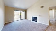 Located at 7971 Rush River Dr in Sacramento, CA, this well-appointed two-bedroom, two-bathroom residence offers a thoughtfully designed single-floor layout. The open kitchen is fitted with stainless steel appliances, including a refrigerator, range, microwave, and dishwasher, complemented by crisp white shaker cabinetry, granite-style countertops, and light wood-look flooring. A peninsula counter connects the kitchen to the living area, which is finished with a ceiling fan and flows naturally into a comfortable living room. The living room is a standout space, featuring a tiled wood-burning fireplace and a sliding glass door that opens to a private balcony with outdoor views. Both bedrooms are carpeted and bathed in natural light from multiple windows. The generously sized primary bedroom includes a sliding-door closet, while the second bedroom also offers ample space and natural light. The two bathrooms are clean and functional — one features a walk-in shower with a sliding glass door, while the other includes a full soaking tub and shower combination, with white cabinetry and granite-style countertops throughout. A connecting hallway ties the layout together efficiently, making this a practical and inviting home.