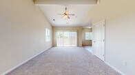Located at 618 E Shade St in Andover, Kansas, this well-appointed one-bedroom, one-bathroom home offers a thoughtfully designed layout with a welcoming entrance. The living area is a standout feature, boasting soaring vaulted ceilings, a ceiling fan with light kit, and plush carpeting throughout. Sliding glass doors and multiple windows flood the space with natural light and provide views of the outdoors, creating an open, airy atmosphere. The kitchen is stylishly appointed with rich dark wood cabinetry, dark granite countertops, a mosaic tile backsplash, black appliances, hardwood-style flooring, and pendant lighting — a functional yet attractive space for cooking and entertaining. The bathroom mirrors the kitchen's refined aesthetic, featuring a dark wood vanity with granite countertops, a framed mirror, a tall storage cabinet, and hardwood-style flooring. The bedroom is a comfortable retreat with plush carpet, a ceiling fan, and a bright window overlooking the neighborhood. Two closets provide ample storage, including a carpeted walk-in closet with wire shelving. A dedicated laundry area with built-in shelving adds everyday convenience. Carpeted staircases with a handrail complete this practical and attractive home.