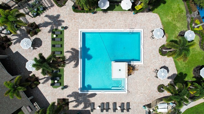 Our resort-style pool is the perfect oasis for relaxation, featuring spacious lounging areas and elegant landscaping. Experience premier living with top-notch amenities designed for your comfort. - Harper Grand